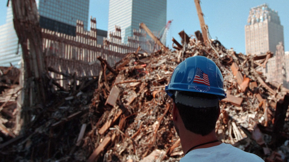 A worker stands in front of rubble from the World Trade Center at Ground Zero in Lower Manhattan several weeks after the September 11 attacks.