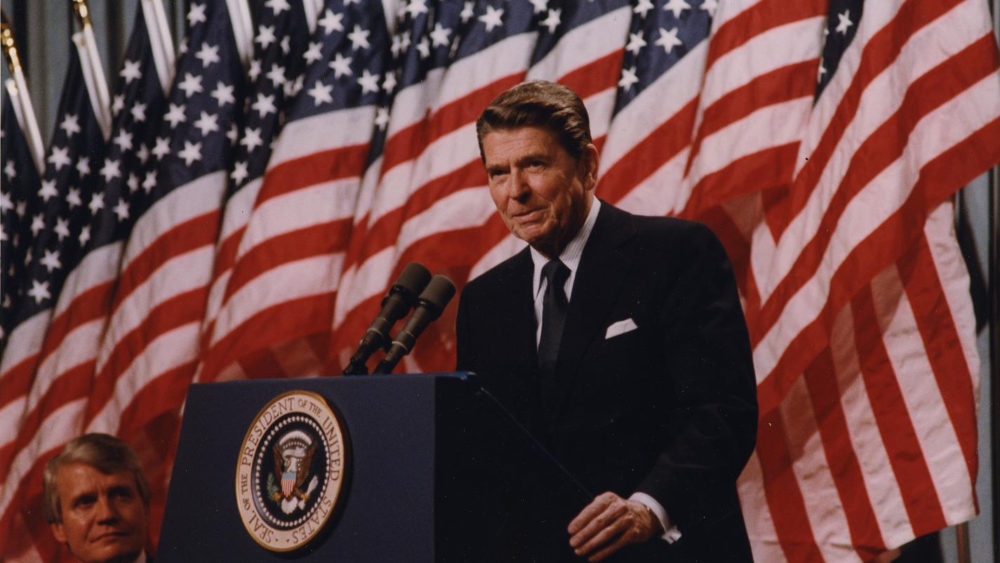 President Ronald Reagan, a master of the "photo op," appears here with a row of American flags at his back at a 1982 rally for Senator David Durenberger in Minneapolis, Minnesota.