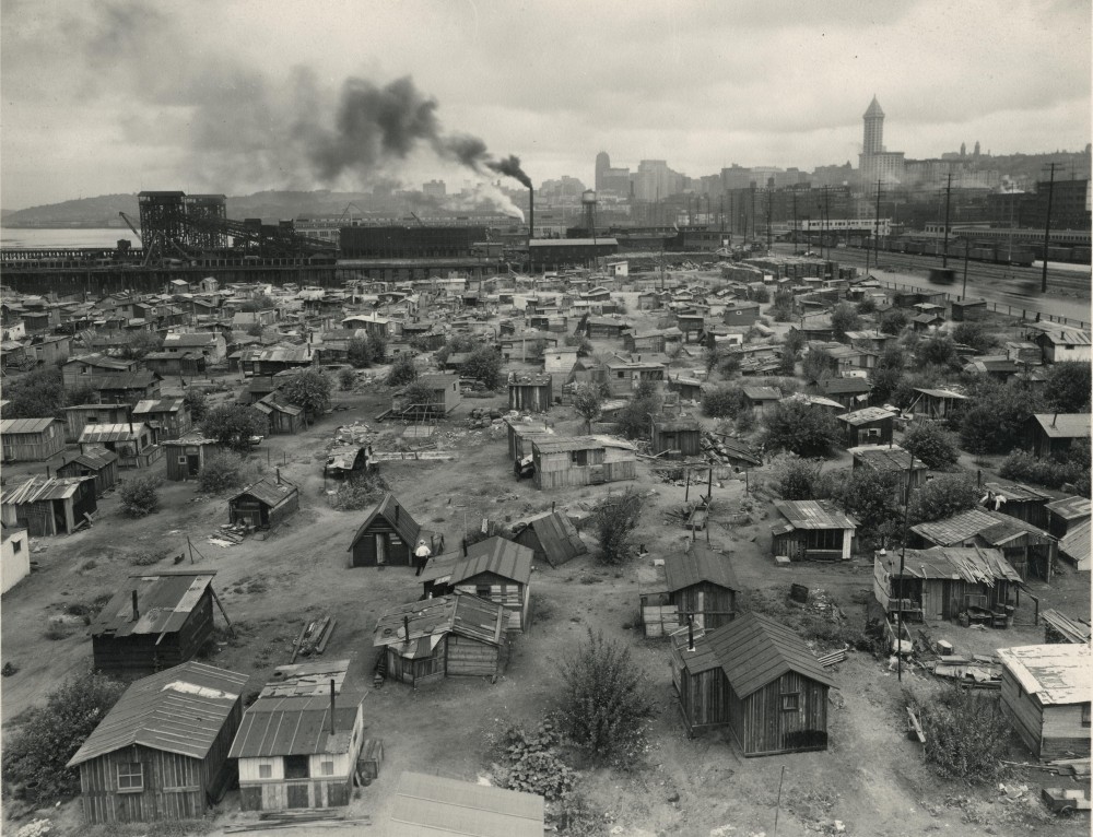A photograph of shacks strewn across a large park. 
