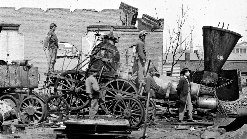 War brought destruction across the South. Governmental and private buildings, communication systems, the economy, and transportation infrastructure were all debilitated. “[Richmond, Va. Crippled locomotive, Richmond & Petersburg Railroad depot],” c. 1865. Library of Congress.