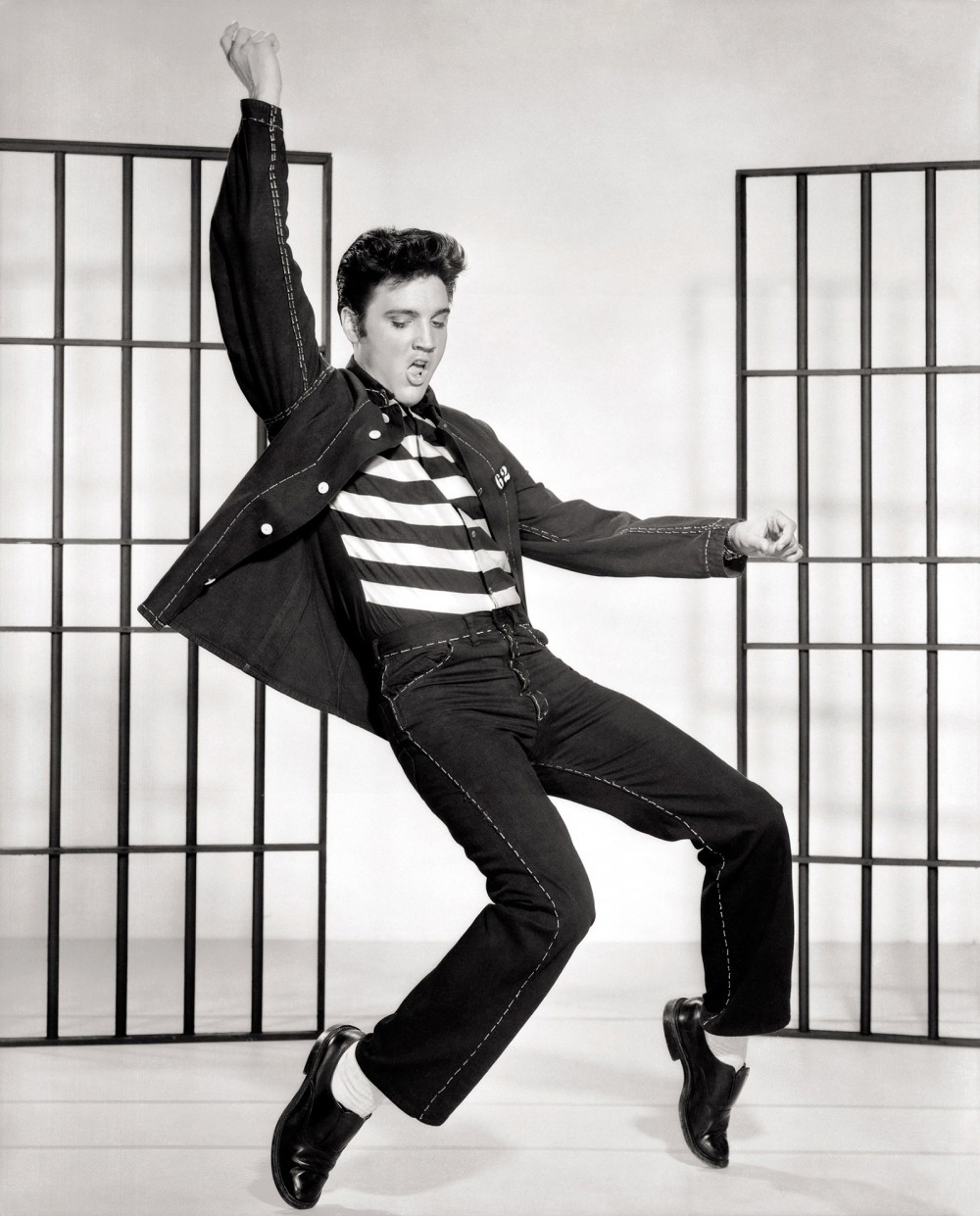 This photograph of Elvis depicts the rock star dancing. 