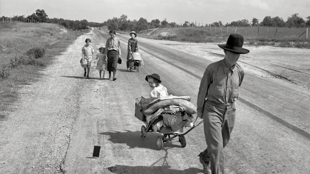 During her assignment as a photographer for the Works Progress Administration (WPA), Dorothea Lange documented the movement of migrant families forced from their homes by drought and economic depression. This family was in the process of traveling 124 miles by foot, across Oklahoma, because the father was unable to receive relief or WPA work of his own due to an illness. Dorothea Lange, “Family walking on highway, five children” (June 1938) Works Progress Administration, Library of Congress.