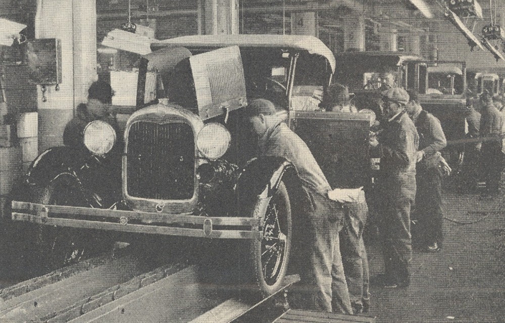 Photograph of an assembly line at a Ford plant. 