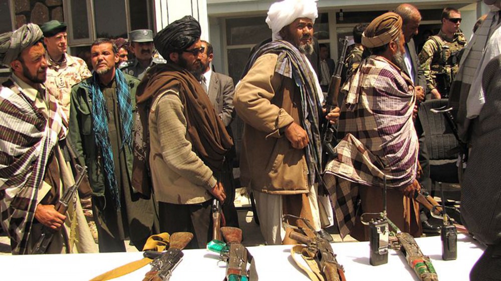 Photograph of former Taliban fighters surrendered their arms to the government of the Islamic Republic of Afghanistan during a reintegration ceremony. 