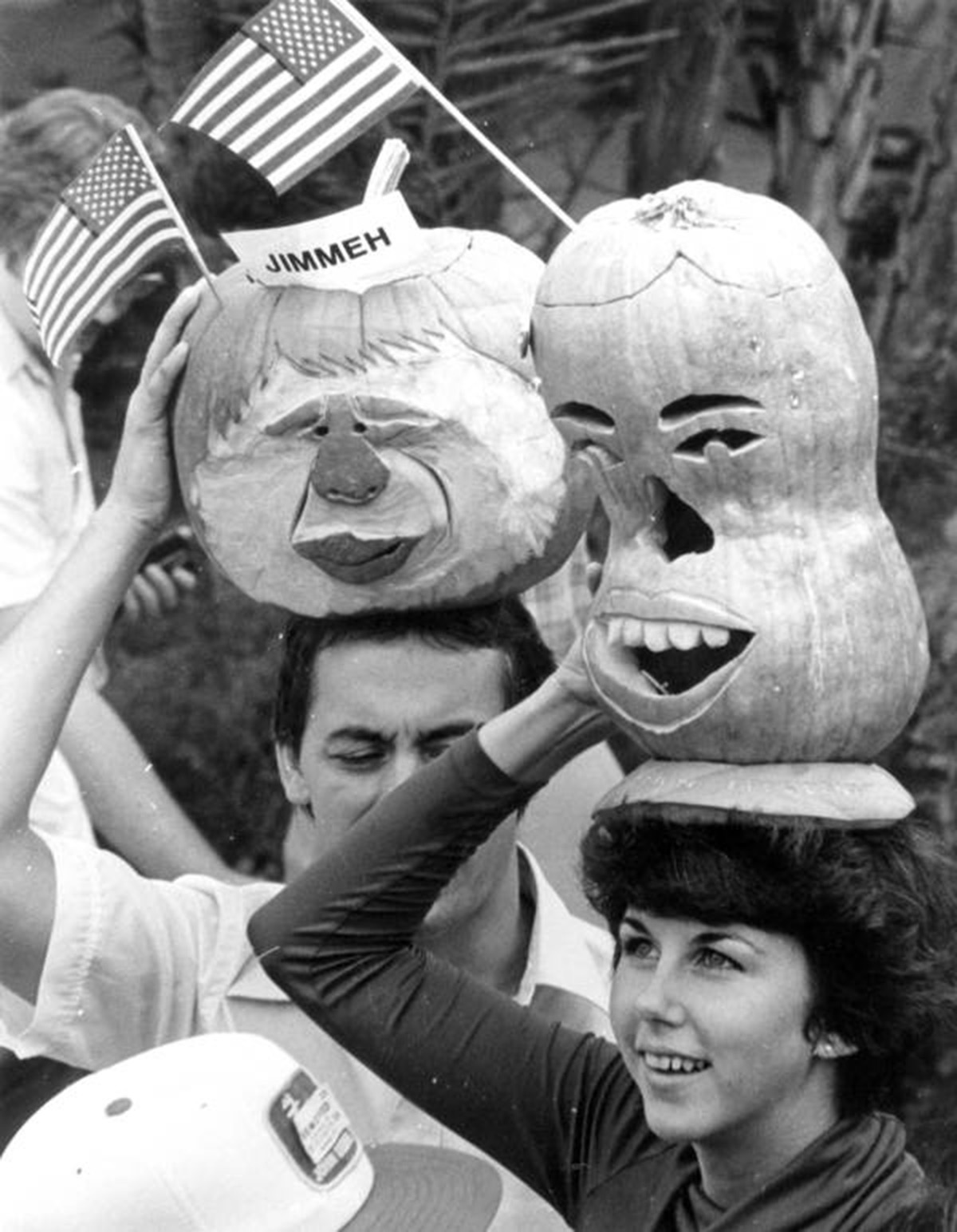 Photograph of Jimmy Carter-supporters with pumpkins carved in the likeness of Carter. 