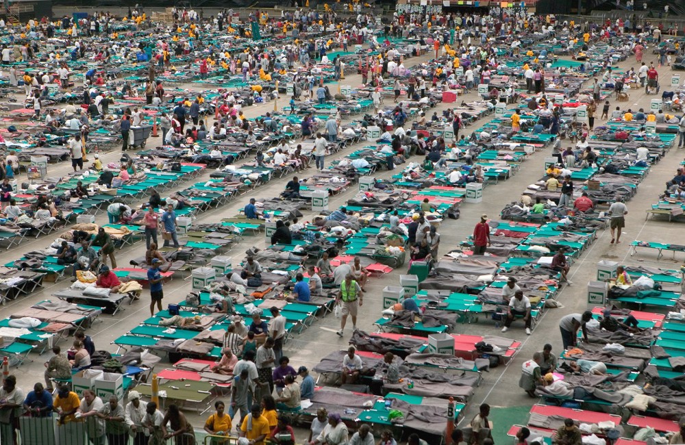 Photograph of hundreds of refugees from Hurricane Katrina living on cots in the Houston Astrodome. 
