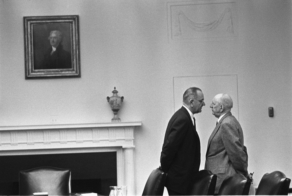 Photograph of President Lyndon B. Johnson leaning very close into the face of Senator Richard Russell. 