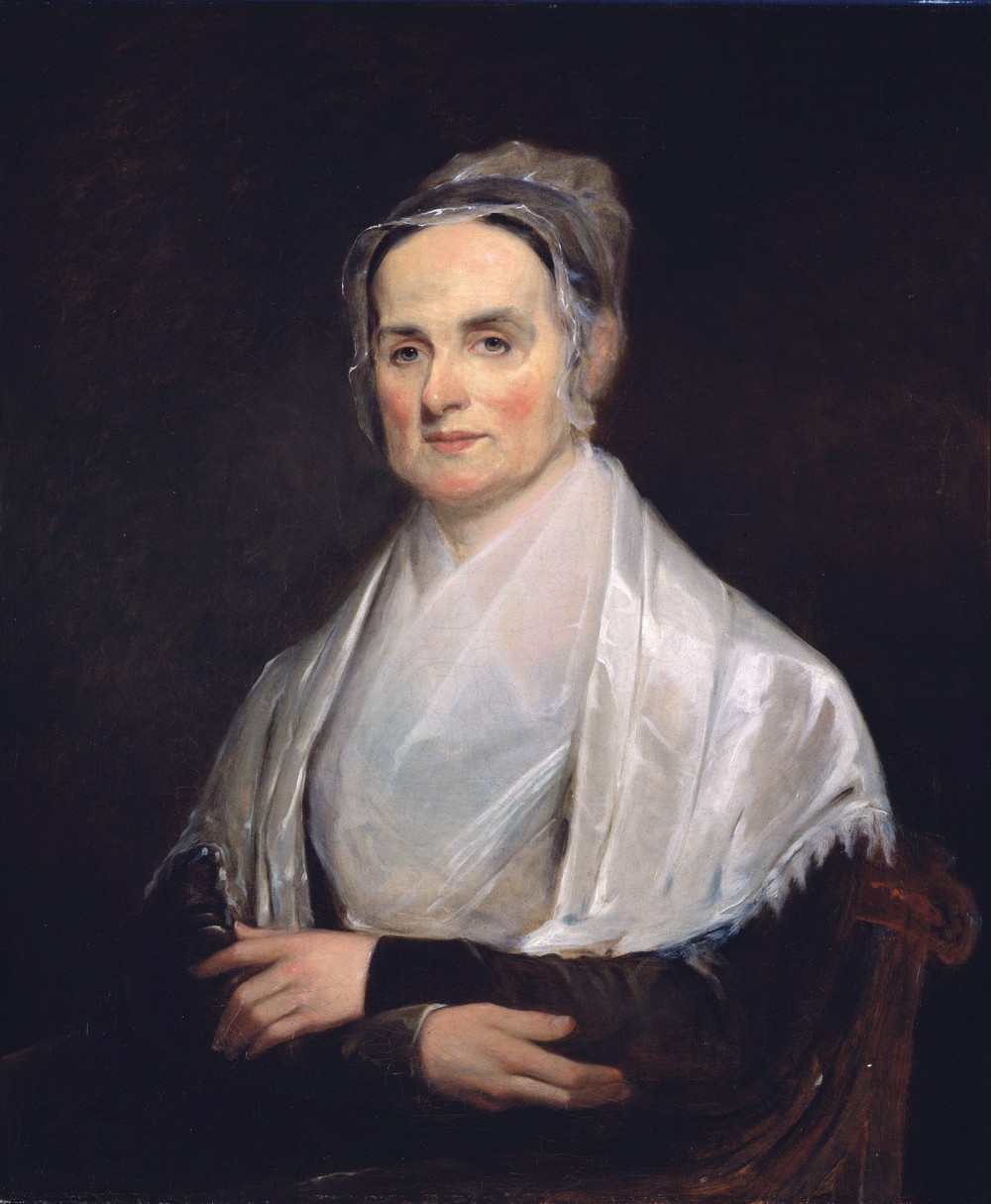 A painting of the reformer Lucretia Mott. She is seated wearing a shawl and bonnet. 