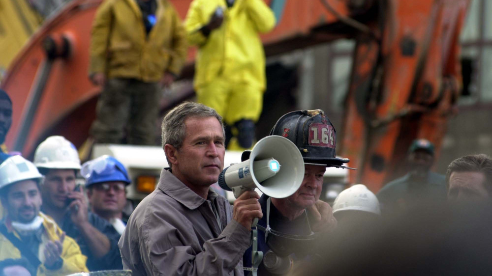 President Bush addresses rescue workers at Ground Zero of the World Trade Center disaster. Thomas R. Roberts, New York, NY, September 14, 2001. Via FEMA Photo Library. 