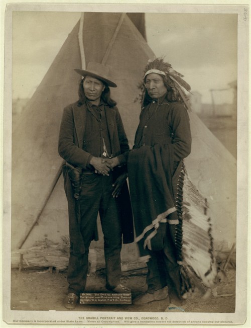 Red Cloud and American Horse – two of the most renowned Ogala chiefs – are seen clasping hands in front of a tipi on the Pine Ridge Reservation in South Dakota. Both men served as delegates to Washington, D.C., after years of actively fighting the American government. John C. Grabill, “‘Red Cloud and American Horse.’ The two most noted chiefs now living,” 1891. Library of Congress, http://www.loc.gov/pictures/item/99613806/. 