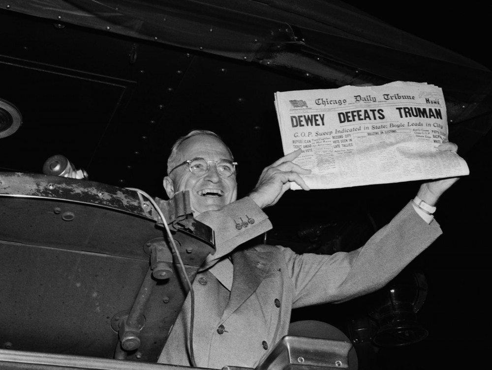 In this photograph Harry Truman holds up a newspaper with the incorrect headine "DEWEY DEFEATS TRUMAN."