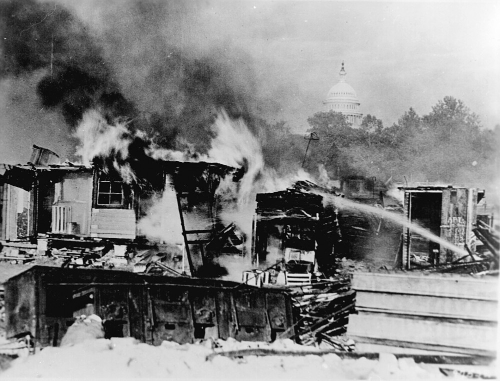 Photograph of shacks, put up by the Bonus Army on the Anacostia flats, Washington, D.C., burning after the battle with the military. The Capitol in the background. 1932. Wikimedia, http://commons.wikimedia.org/wiki/File:Evictbonusarmy.jpg. 