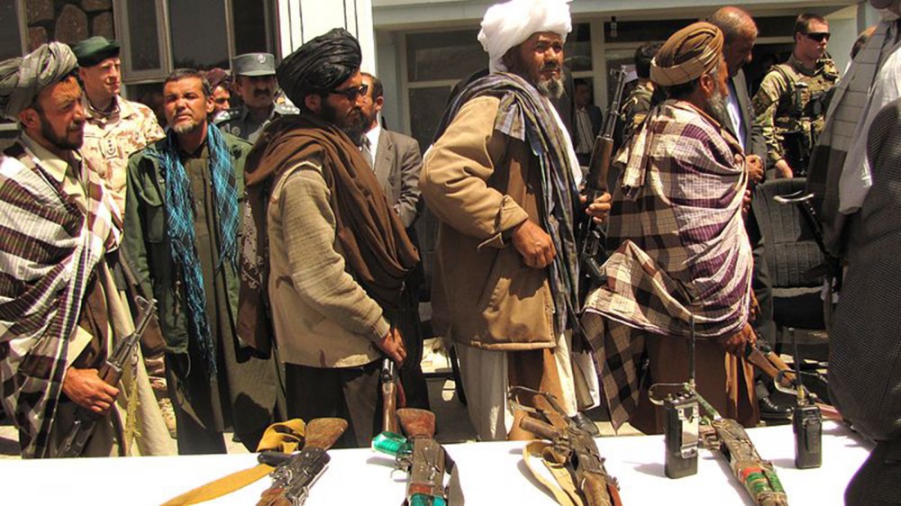 Photograph of former Taliban fighters surrendered their arms to the government of the Islamic Republic of Afghanistan during a reintegration ceremony.