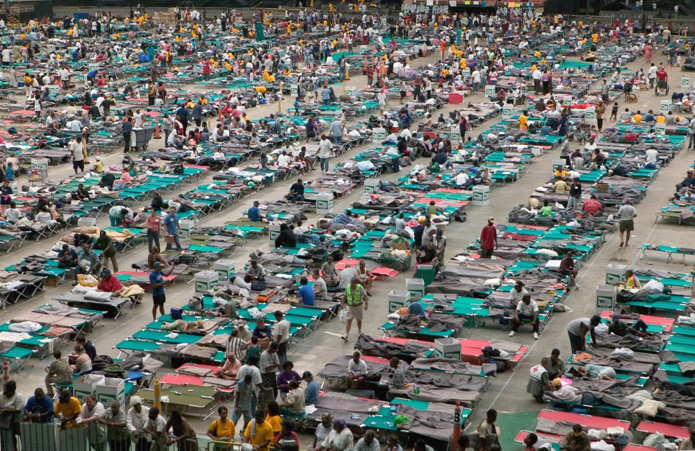 Photograph of hundreds of refugees from Hurricane Katrina living on cots in the Houston Astrodome.