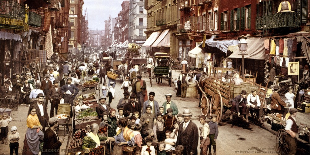 Colorized photo of a crowded, bustling "Mulberry Street, New York City," in 1900.