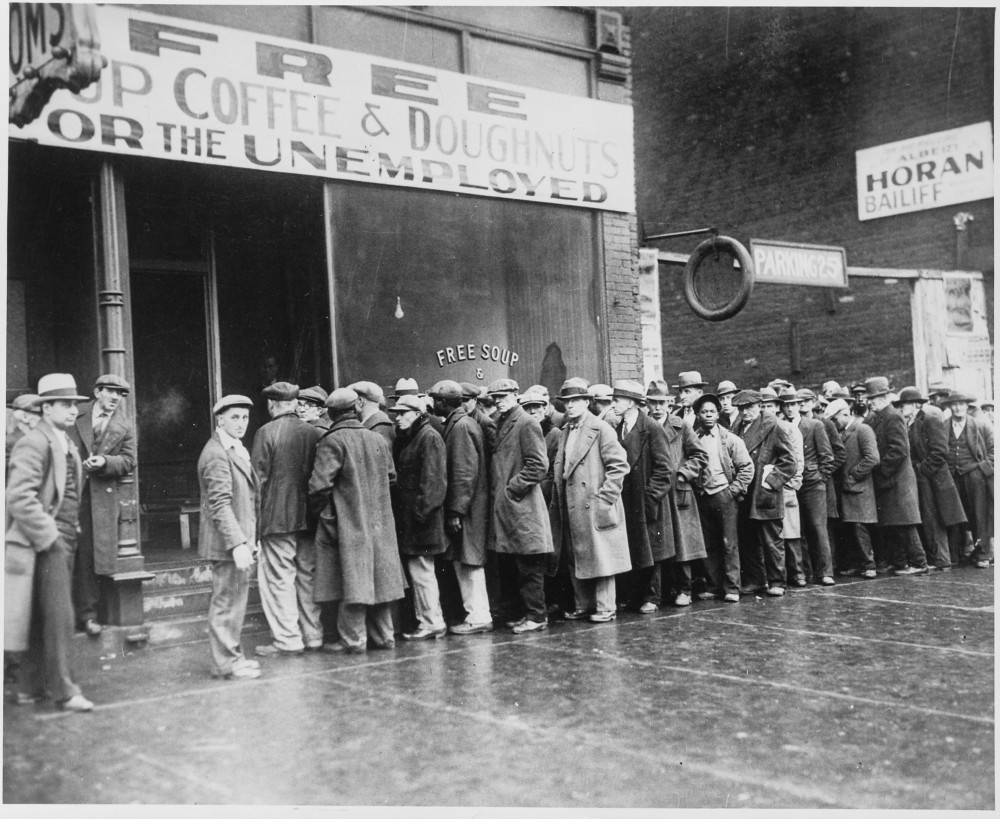 Photograph of unemployed men queued outside a depression soup kitchen opened in Chicago by Al Capone,” February 1931. Wikimedia, http://commons.wikimedia.org/wiki/File:Unemployed_men_queued_outside_a_depression_soup_kitchen_opened_in_Chicago_by_Al_Capone,_02-1931_-_NARA_-_541927.jpg. 