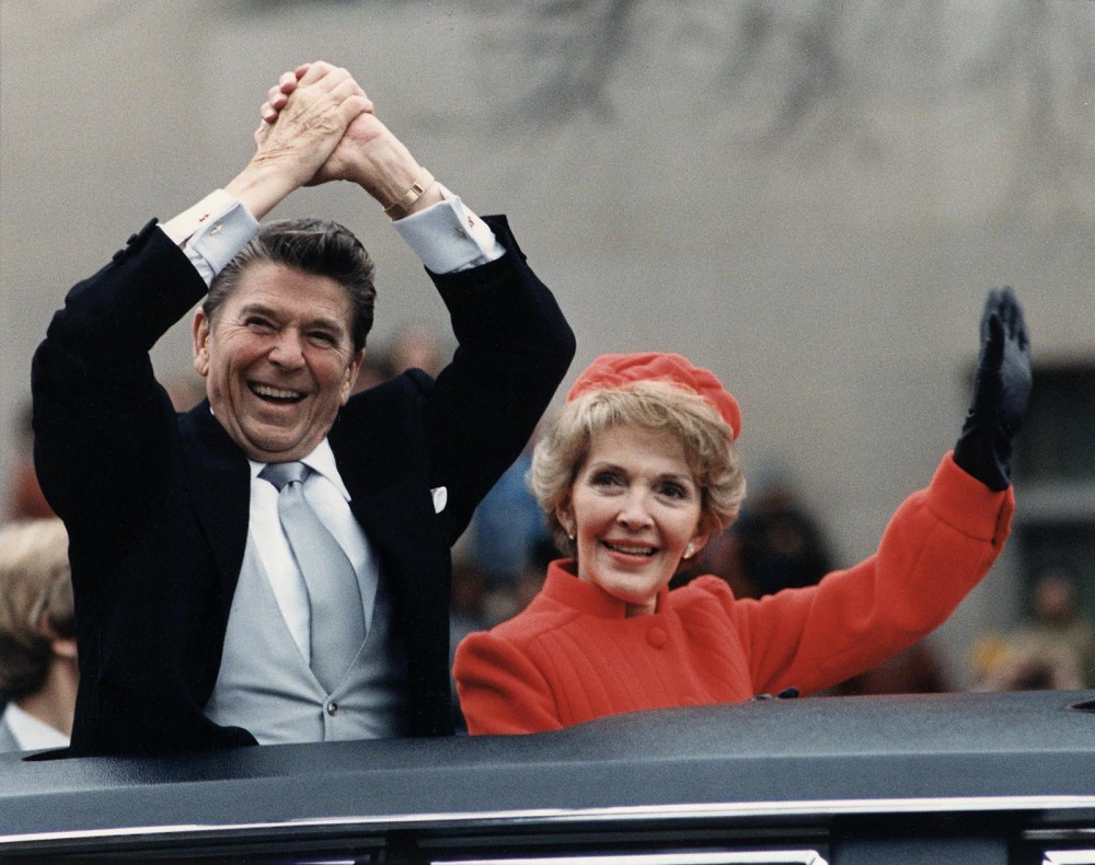 Photograph showing Ronald Reagan and his wife, Nancy Reagan, waving from a limousine during the inaugural parade in Washington, D.C., in 1981. 