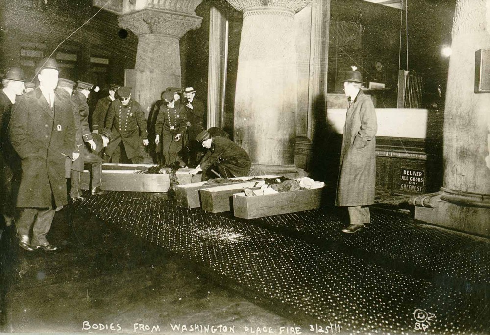 Photographs like this one made real the potential atrocities resulting from unsafe working conditions, as policemen place the bodies of workers burnt alive in the 1911 Triangle Shirtwaist fire into coffins. “Bodies from Washington Place fire, Mar 1911,” March 25, 1911. Library of Congress, http://www.loc.gov/pictures/item/98502780/. 