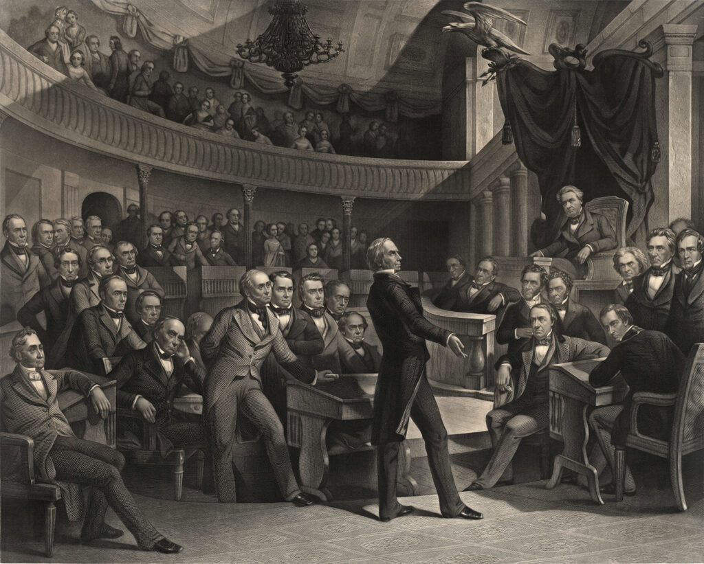 Henry Clay (“The Great Compromiser”) addresses the U.S. Senate during the debates over the Compromise of 1850. The print shows a number of incendiary personalities, like John C. Calhoun, whose increasingly sectional beliefs were pacified for a time by the Compromise. P. F. Rothermel (artist), c. 1855. Wikimedia. The scene shows a crowded legislative hall with ornate neoclassical architecture, including columns, draped decorations, and a curved gallery filled with spectators. Clay stands at a podium addressing the assembled senators, who are seated at their desks wearing frock coats and formal attire. 