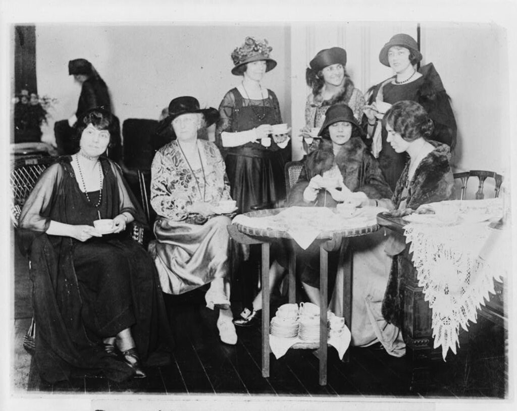 Women sit and drink tea.