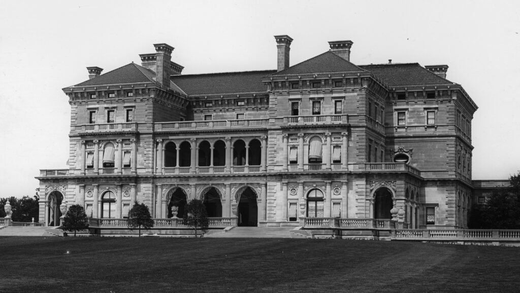 The exterior of an opulent, three-story mansion.