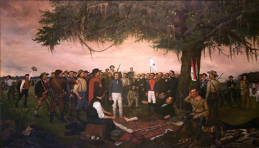 This painting depicts Santa Anna surrendering to Sam Houston following the Battle of San Jacinto in 1836. And injured Sam Houston sits on a blanket under a tree with his right leg bandaged. He is extending his hand up toward Santa Anna who is standing over Houston, to accept Santa Anna’s surrender. One of Santa Anna’s officers stands near him. Crowded around these three men is a crowd of Texas soldiers, watching carefully. Raised high behind the line of soldiers is a white flag with a star in the middle, meant to represent Texas’ “Come and Take it” flag, a symbol of the Texas Revolution.