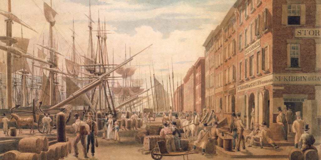This painting shows a busy port station in New York City in 1827. The left side of the painting depicts a row of merchant ships docked in a harbor. People line the foreground of the painting from left to right, many engaged in conversation with others, some are standing near horse draw carriages, some are sitting on barrels of hay, some are sitting on the street corners, some lean and sit on wooden barrels, some are walking into merchant shops, and one family standing to the center left of the scene points to the docked ships.