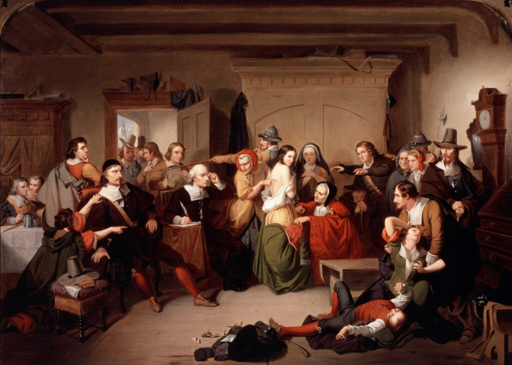 Oil on canvas by Tompkins Harrison Matteson, 1853. This historical painting depicts a dramatic scene with people in black garments, white collars, and tall hats. At the center, several figures in dark clothing appear to be examining or confronting women in lighter dress, including one in white and another in red. A man lies on the floor in the foreground. 