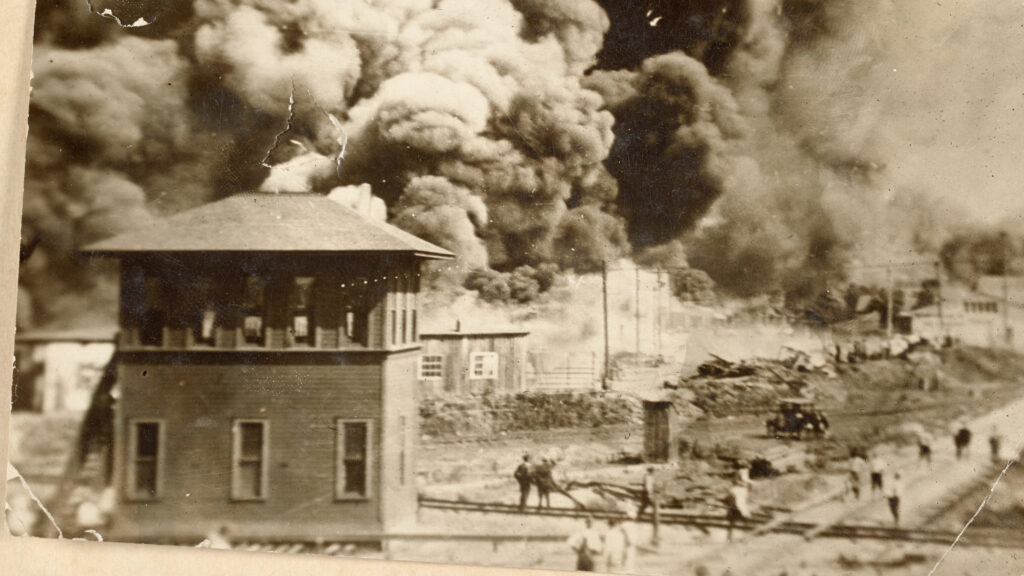 Fires burn in a city.