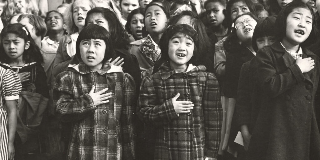 American children of Japanese descent in San Francisco recite the Pledge of Allegiance.